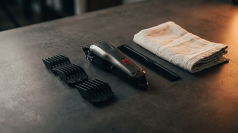 Professional barber clippers and guards laid out on charcoal — Republic Of Barbers, Unley Road, Malvern, serving Fullarton