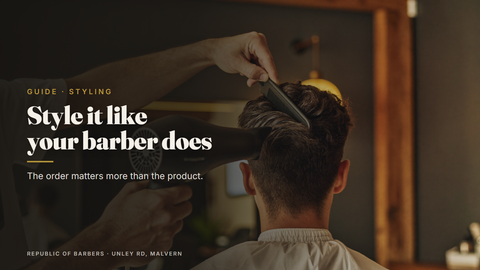 Barber blow-drying and combing a client's hair into shape at Republic Of Barbers, Unley Road, Malvern
